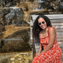 Kristen Halliday sits on a bench next to a waterfall.