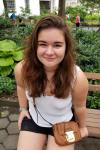 Image of Sasha sitting on a park bench