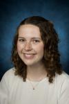 Headshot of Haley Mullen. Haley is wearing a white shirt and smiling.