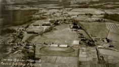 A 1926 aerial view of the Maryland Agricultural College shows the old stadium where Fraternity Row now stands.