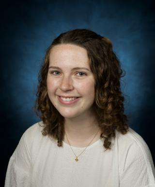 Headshot of Haley Mullen. Haley is wearing a white shirt and smiling.
